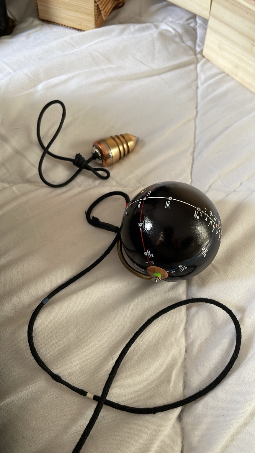 Anna Cala’s black universal pendulum with radiesthesia markings